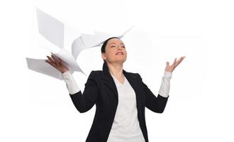 Business woman throwing work papers in the air. Stress from workload. photo