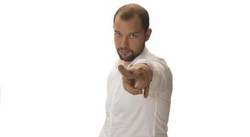 Portrait of young man pointing forward, looking at camera. Choosing someone concept photo