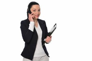 Portrait of a smiling young business woman talking on mobile phone and looking away at copy space isolated over white background photo