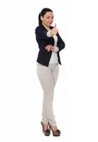 Happy business woman showing thumb up and looking at the camera over gray background photo