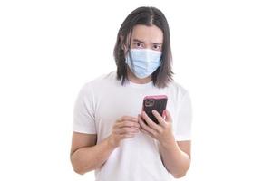 Protection against contagious disease, coronavirus, covid-19. Asian Man wearing hygienic mask and holding his cell phone. Preventing infection, airborne respiratory illness such as flu, 2019-nCoV. photo