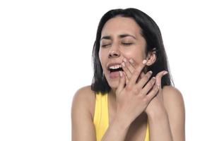 Tooth Pain And Dentistry. Beautiful Young Woman Suffering From Terrible Strong Teeth Pain, Touching Cheek With Hand. photo