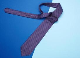 blue silk tie with polka dots on blue background