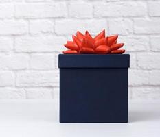 blue square cardboard box with red bow photo