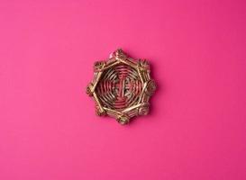 wicker decorative nest on a pink background photo