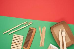 various household items from recyclable raw materials on a green background photo