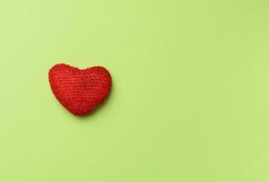 red heart on a green background photo
