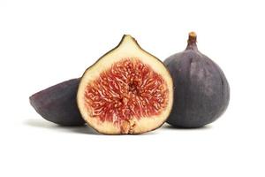 ripe whole and halved purple figs isolated on white background photo