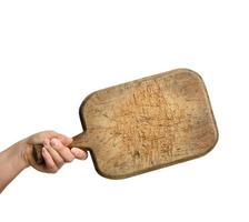 woman holding blank brown rectangular wooden board in hand photo