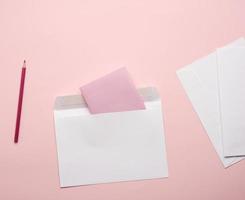 white envelopes on a pink background photo