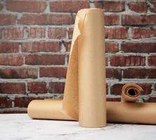 rolls of brown parchment paper on a white table photo