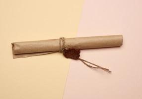 brown paper roll sealed with wax seal, top view photo