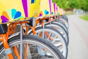 A number of beautiful bicycles are rented on street photo