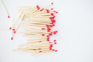 Long matches with a red head on a white background. photo