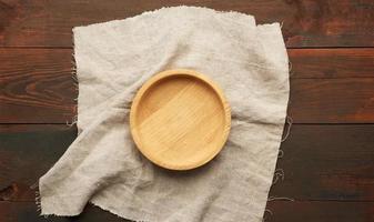 empty round brown wooden plate on table photo