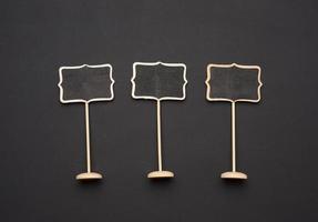 wooden pointer on a stick for writing text, black background photo