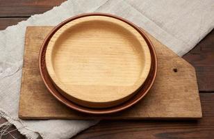 empty round brown plate standing on a gray linen napkin photo