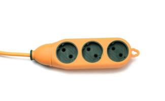 rubber orange power strip with three sockets isolated on white background photo