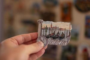 Venice Italy souvenir refrigerator magnet at hand. photo