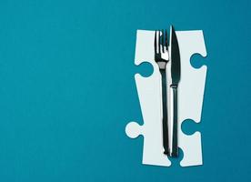 fork with knife on a blue background, top view. Table setting photo