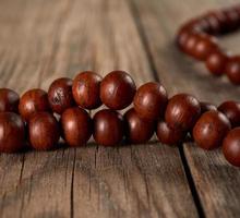 brown wooden prayer rosary on a wooden table