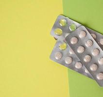 blister packaging with round pills on green background photo
