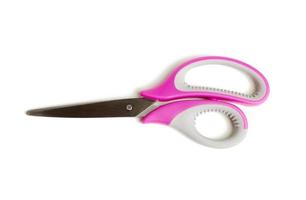 metal scissors with pink plastic handle isolated on white background photo