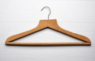 vintage wooden hanger with iron hook on white background photo