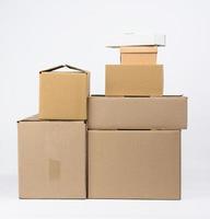 stack of closed cardboard brown paper boxes on white background, moving concept photo