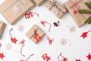 gift boxes wrapped in brown paper and tied with a golden ribbon on a white background photo