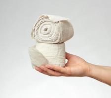 woman holds in hand a white elastic bandage for the body photo