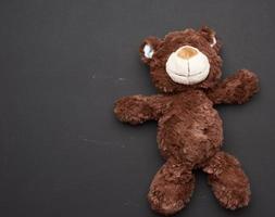 brown teddy bear on a black chalk board background photo