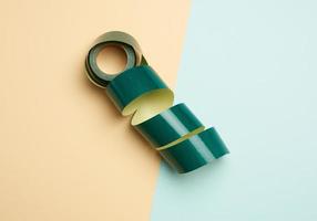 roll of rolled paper sticky tape on colored background photo