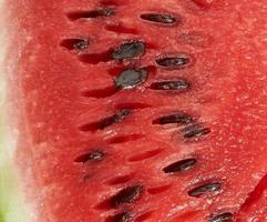 texture of red ripe watermelon with brown seeds, full frame photo
