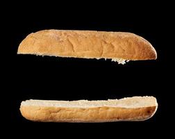 halved baked ciabatta loaf isolated on black background, sandwich blank photo