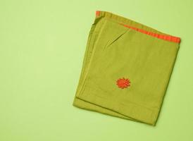 folded green napkin, green background photo