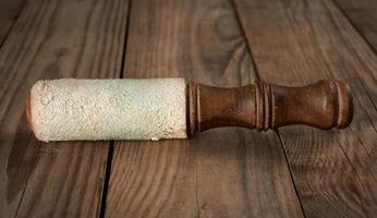 wooden clapper for singing bowls on a gray wooden background photo