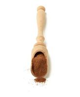 brown ground cinnamon in a wooden spoon photo