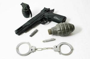 Grenade Bullets Gun and Handcuffs photo