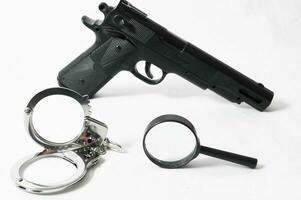 Weapon Crime Concept Gun and Handcuffs photo