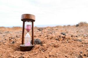 Hourglass on the ground photo