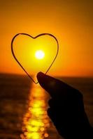 Heart shape over the sunset photo