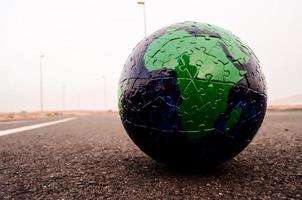 Puzzle globe on the road photo