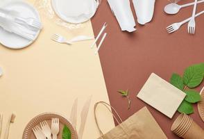 non-degradable plastic waste from disposable tableware and a set of dishes from environmental recycled materials photo