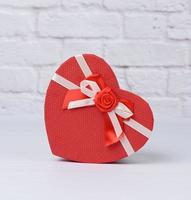 red cardboard box in the shape of a heart on a white background photo
