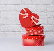 stack of various red boxes with gifts on white background photo