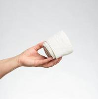 woman holds in hand a white elastic bandage for the body photo