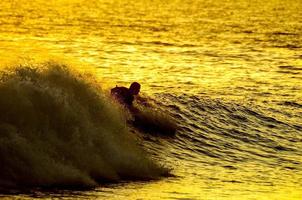 Surfer over the sunset photo