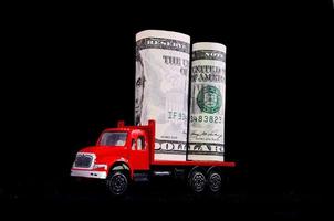 Red toy truck carrying cash photo