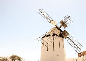 Traditional windmill under clear blue sky photo